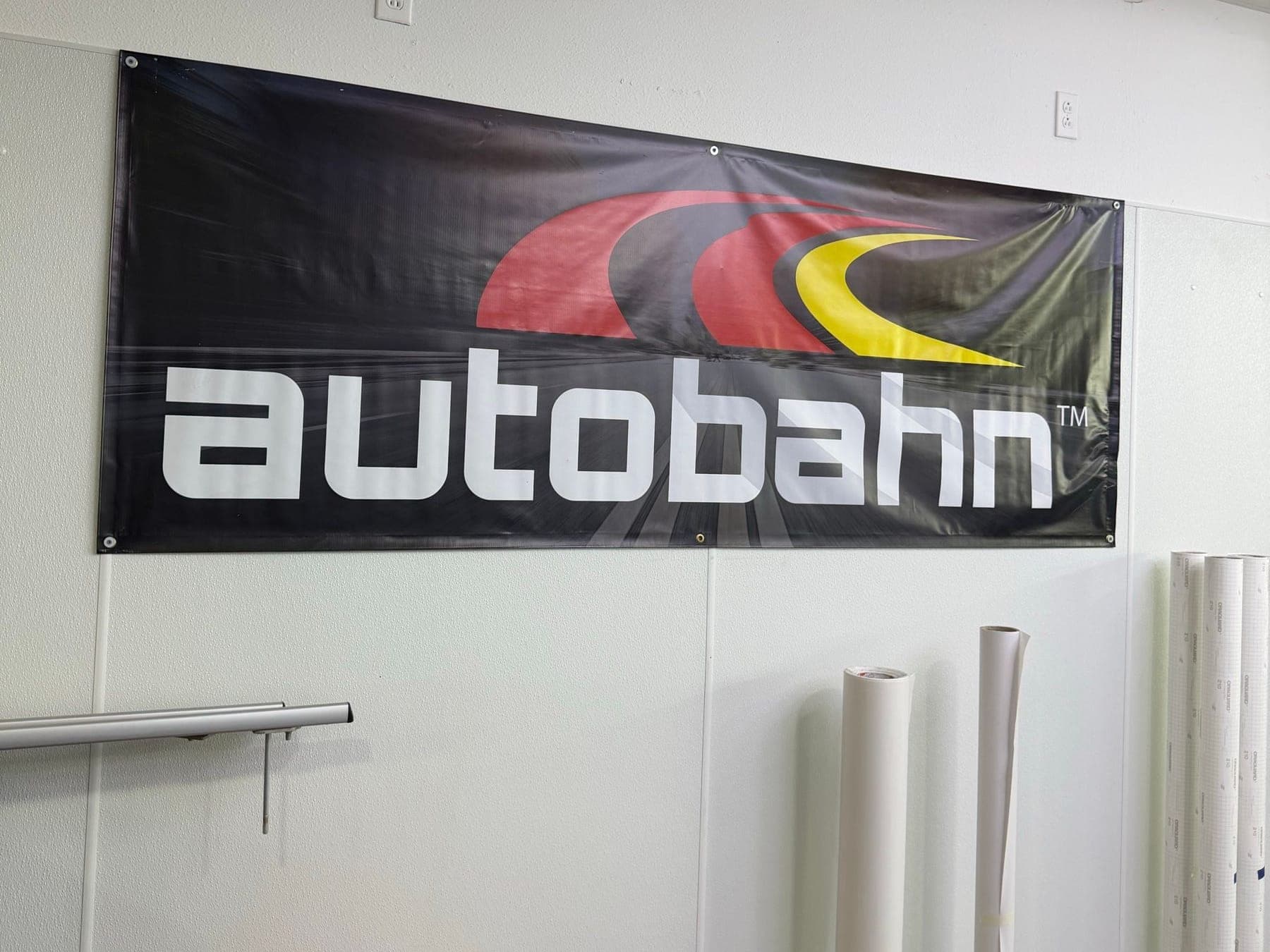 Autobahn banner and rolls of film material inside the Ironwood Motorsports shop
